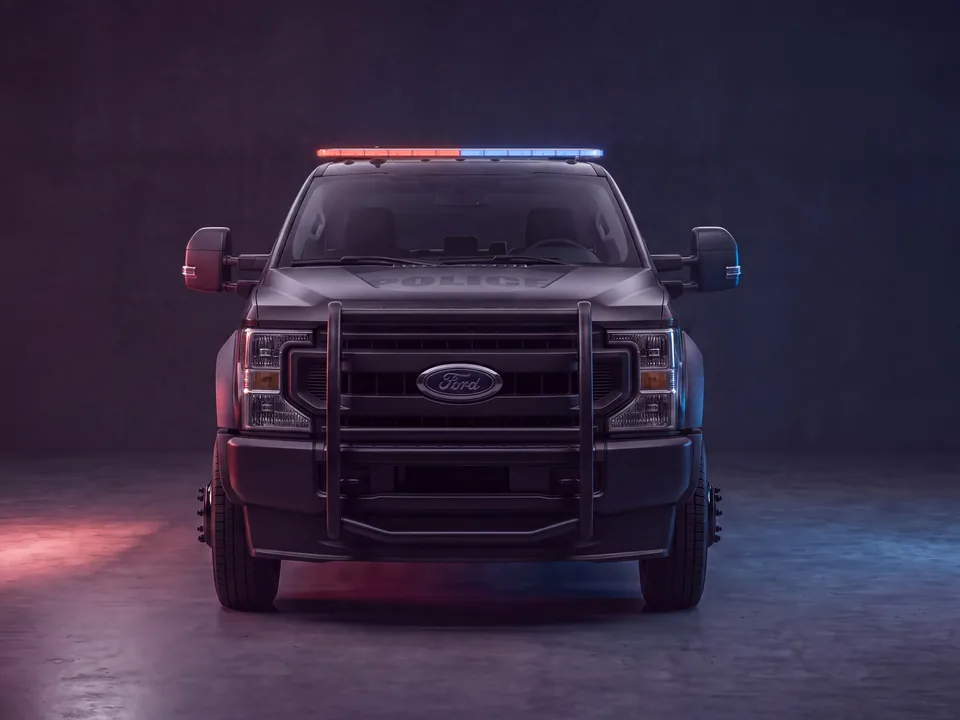Police Ford F-450 wearing a Quantum 60 light bar, lit red and blue