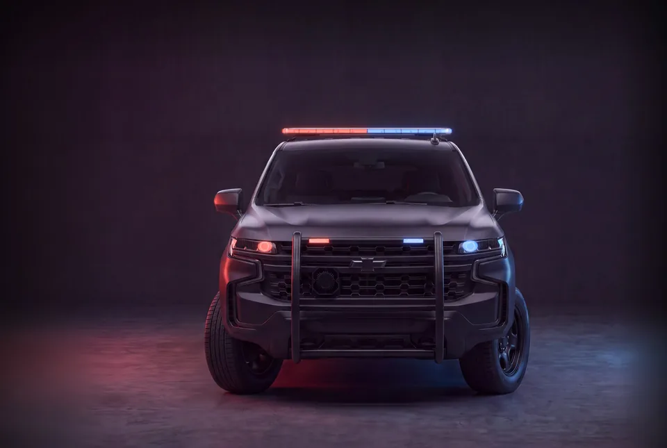 Police Chevy Tahoe wearing a Quantum 49 light bar, grille surface mounts and Cannons, lit red and blue