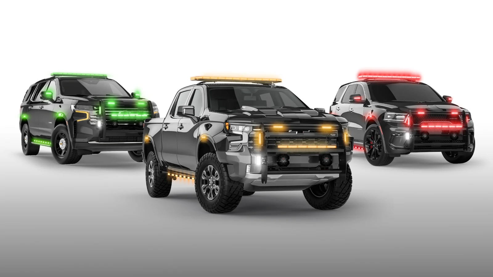 Three emergency vehicles, one lit green, one amber and one red